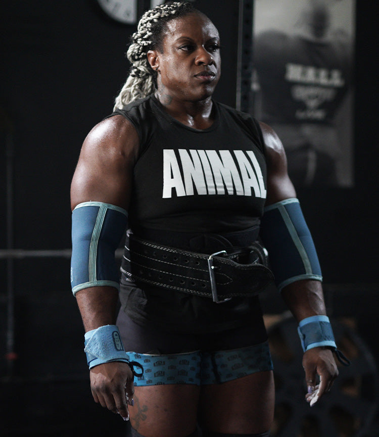 NADIA STOWERS wearing a black 'ANIMAL' tank top in a gym setting
