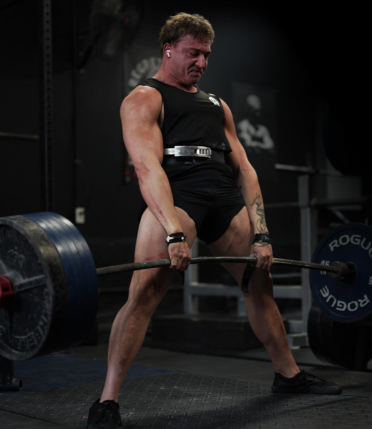 Tyson Ridenour lifting a barbell in a gym